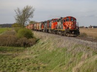 One of the most interesting things left to get photos of nowadays on CN - the GP9RM's have been a staple of the railfanning scene for over 40 years.  With the retirement over the past few years of all mainline "sergeant stripes" units, these are some of the most notable locomotives with the scheme remaining intact.  CN is also the last class one railway in North America to roster GP9's of any kind, the oldest still currently rostered just having turned 70 years old last year (CN 4125).
<br>
Seen here at Manning Drive south of London, CN 4141 is a recent transfer unit from the Montreal power pool.  It has proven to be a reliable puller, and the London crews have taken a liking to it.  Trailing behind, 4790 has been a staple of the Southern Ontario power pool for years, and 4936 is one of the more recent additions.  In the photo, L584 is heading south to St. Thomas where they will interchange cars with OSR and GIO, along with working the Formet plant.  I used to watch 584 at this spot when I was much, much younger, and the power has stayed mostly the same.  This train is also the last amount of business CN has in the city of St. Thomas, no longer running any of their own trains on the Cayuga/Paynes Subdivisions, and the CASO Subdivision running west out of St. Thomas being closed and abandoned for over 20 years.  
<br>
Hopefully the GP9RM's last a little bit longer.  People seem to have been saying they're on the brink of retirement for the past couple of years, but they just keep soldiering on.
