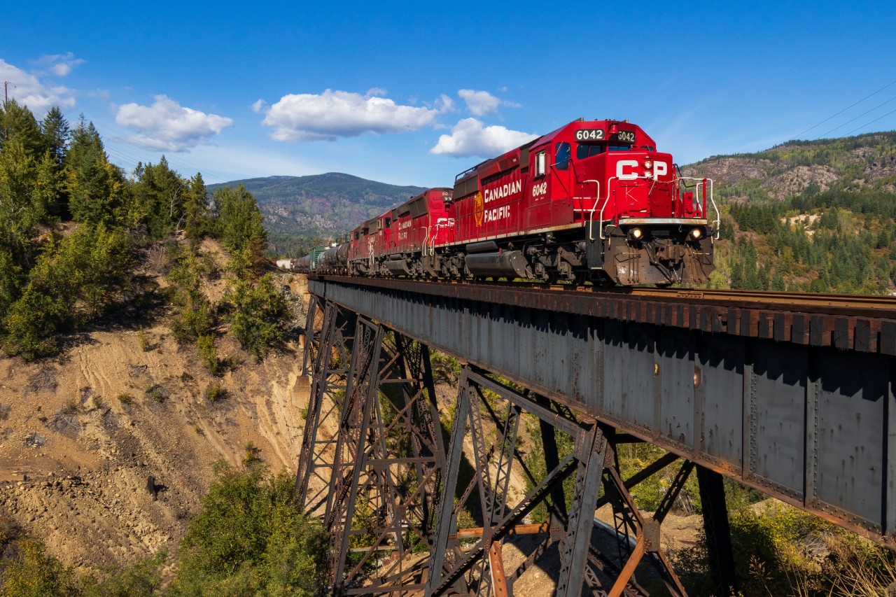 This might be the most attention that Trail BC has ever received on Railpics haha. With 2 other posts already up, I figured I'd add my own photo of modern day. The Kootenay Valley Railway "hotshot" is on the last leg of its 330 mile journey from Golden BC to Trail BC as it glides over the Stoney Creek trestle in the neighbourhood of Tadanac at a calm 10mph. The KVR is an internal shortline that CP has which picks up the wayfreight at McConnell yard in Kitchener BC and takes it round trip to Trail. Once in Trail, they change ends, become CP A18, and set off eastbound to Golden. The entire trip takes 3 days, and runs daily so there are always 3 sets of EMDs running around in the Kootenay Valley region of Southern BC. A18 this day was led by SD40-2 CP 6042, with CP 5003, and CP 2302 trailing. By the way, the hotshot nickname was given to the train ironically as they never reach speeds above 15mph on the KVR.