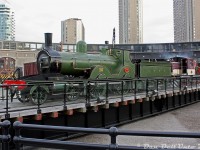 Fitting in perfectly with her surroundings (s steam-era roundhouse, and restored turntable) London & South Western Railway 563 'Vicky' (a T3-class 4-4-0 passenger steam engine originally built in 1892, and retired in 1945) is spun around on the ex-CPR John Street Roundhouse turntable, in preparation for being <a href=https://www.railpictures.ca/?attachment_id=58934><b>put away inside the roundhouse</b></a>. TRHA's CLC-Whitcomb center-cab switcher 1 is seen doing the honours.
<br><br>
At the time, L&SWR 563 had been loaned for 'The Railway Children' production being put on in a tent set up on the Toronto Railway Museum's grounds, and was moved around by the TRHA's switcher during and after the production. Its current home is at the Swanage Railway in the UK.