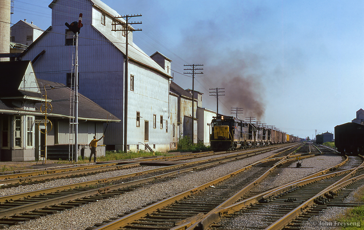 Rumbling east out of the evening sun, what is likely NI42 approaches the depot at Blenheim, where the operator is ready to hoop up the orders.  Note the single-stall engine house in the distance at right.

Scan and editing by Jacob Patterson.