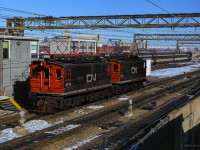 A pair of CN's boxcab electrics back towards their consist at Gare Centrale.  6714 has been preserved at the Halton County Radial Railway, awaiting restoration, and 6715 now resides at the Museum of Science and Technology in Ottawa.<br><br><i>Scan and editing by Jacob Patterson.</i>