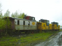 <b> End of the train at the end of the line </b> <br>
17 years ago today on May 19, 2009 ONT 104, ONT 125, and ONT 127 have reached the end of their days of bringing up the markers of ONR freights. <br>
It is an overcast and rainy day in ONR's North Bay yard which seems to magnify the sad end for this trio of cabooses. :-(