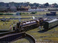 The view from the roundhouse.  CNR 6167 is seen on the first trip of her excursion career, sponsored by the Upper Canada railway Society, at the Niagara Falls Roundhouse on July 10, 1960.  Having run Toronto - Niagara Falls via Hamilton - Caledonia - Welland Junction - Pot Robinson - Stamford, 6167 will be spun on the turntable, and topped up with coal and water before departing for Toronto Union Station.

<br><br><a href=https://www.railpictures.ca/?attachment_id=46495>Spotted for servicing.</a>
<br><a href=https://www.railpictures.ca/?attachment_id=29331>Coaling up.</a>

<br><br>Take a look at different era of Niagara Falls and the region through <a href=https://experience.arcgis.com/experience/d6985c1b40ca4604bcb7f9716f15a285/page/Page-1>these aerials here</a>


<br><br><i>Ralph L. Phillips Photo, Jacob Patterson Collection Slide.</i>