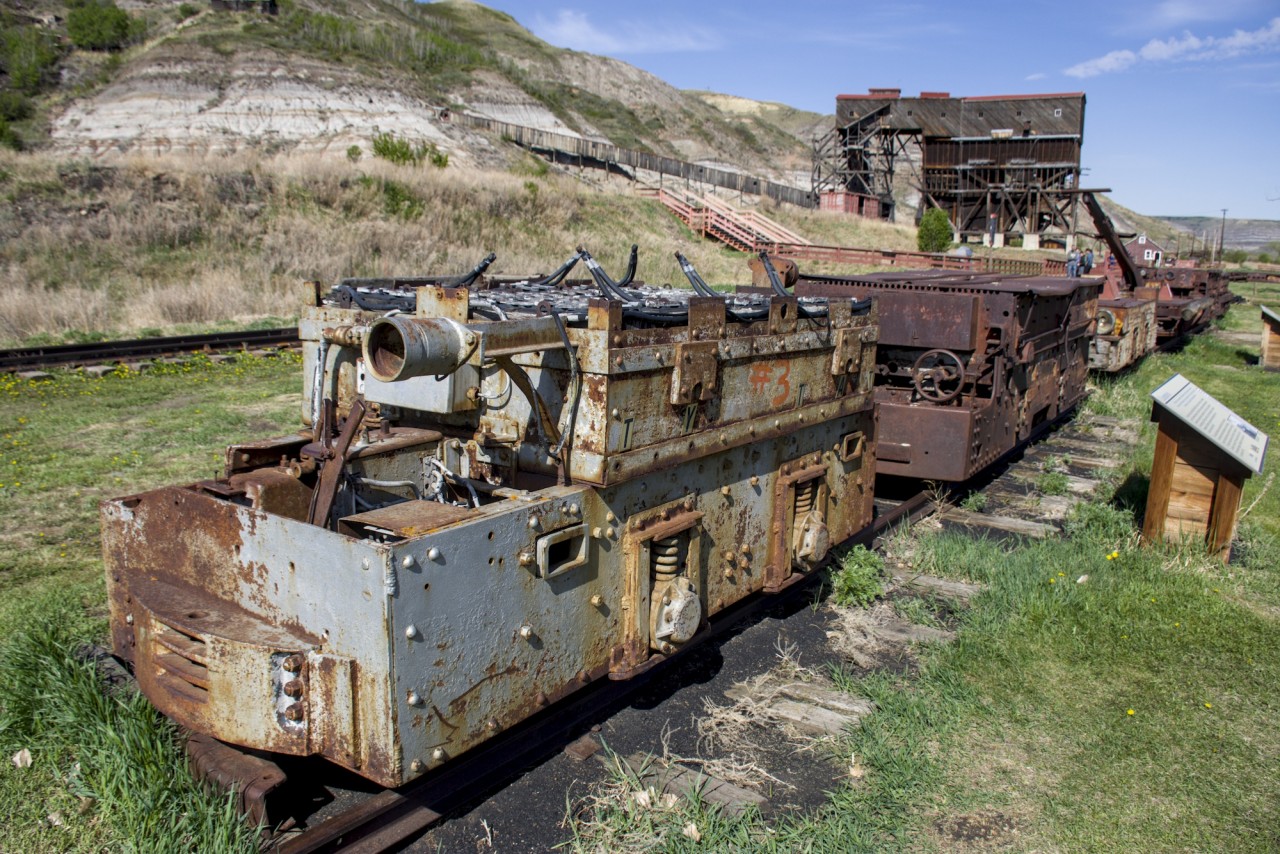 The real tunnel motors... These locomotives are fully electric, despite their age, some using lead acid batteries, or overhead wires. The one pictured here has the batteries visible at the top. the cannon looking thing on the front of the locomotive is actually a headlight, now broken. Specs on this locomotive are not specified, but I think it has around 50+ hp. The coal loading facility is visible in the background with the old right-of-way (The tracks are not visible) positioned beside the old boxcar.
