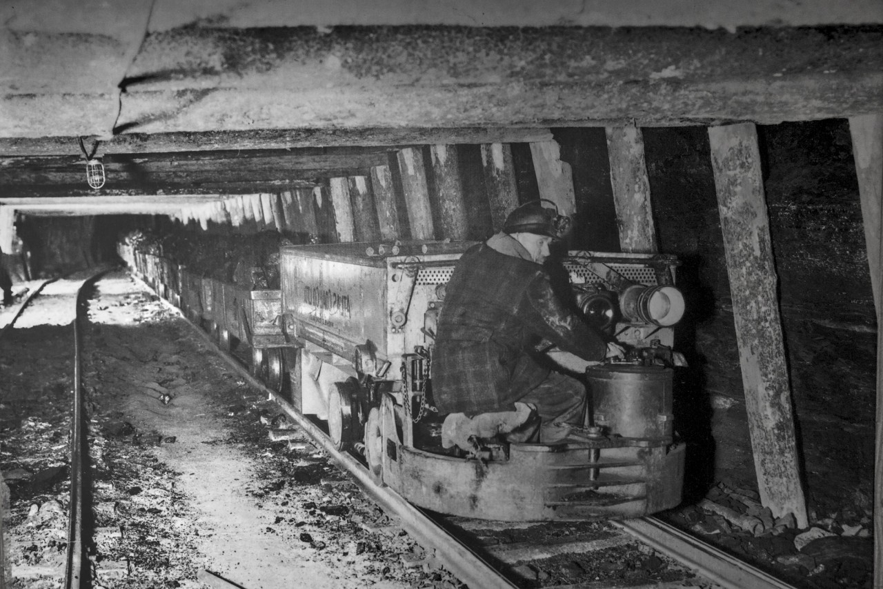 An old picture I found at the Atlas Coal mine. Honestly pretty impressive the guy is wearing a hard hat, but it is very logical. These mining cars used to be pulled by horses. This battery powered steel horse (or tunnel motor) depending on how you put it is much better suited for the job. Not sure on the date.