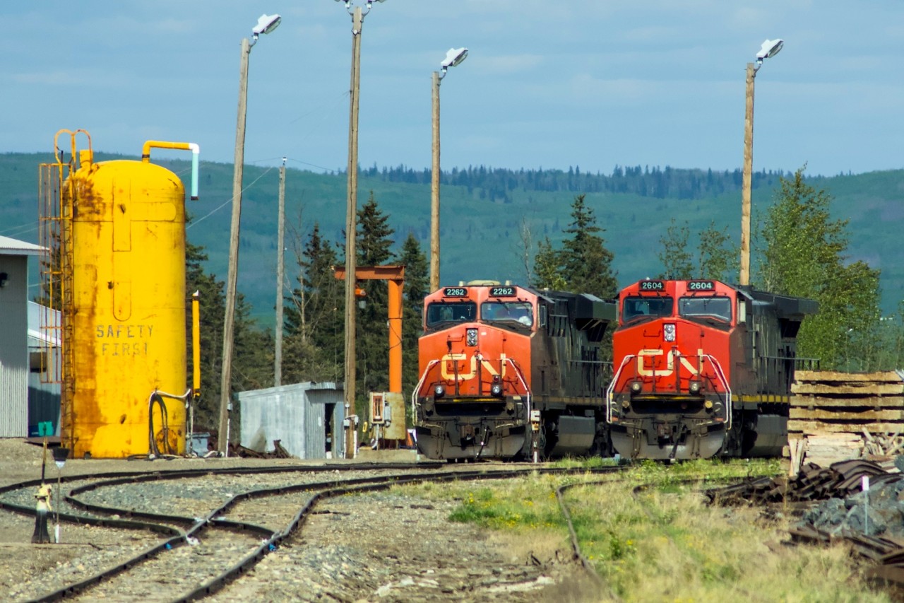 CN 2604 and 2262 sit in the yard on the fueling tracks waiting their next assignment. The rough looking track in the foreground is the spur track that goes to the CANFOR lumber mill where my Dad worked for many years until it shut down.