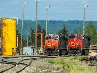 CN 2604 and 2262 sit in the yard on the fueling tracks waiting their next assignment. The rough looking track in the foreground is the spur track that goes to the CANFOR lumber mill where my Dad worked for many years until it shut down. 