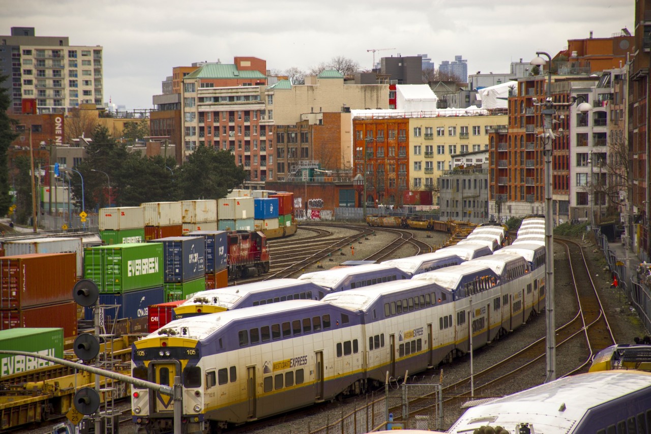 The CPKC Cascade yard (Mile 128). Here we see three WestCoast Express trains and CPKC 2094 sitting in the yard with a cut of intermodal cars. Chinatown can be seen just to the right.