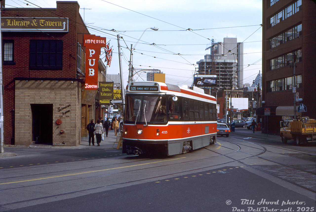 TTC CLRV streetcar 4025 heads westbound on Dundas Street East just past Bond Street, passing the Imperial Pub right where Dundas takes a jog to the north before crossing Victoria Street (also note the track continuing straight, ending at Victoria). On the right is the Bond Place Hotel.

Opened in 1944, the Imperial Pub was an institue on the doorstep of Yonge Street and Dundas Square that would serve patrons in Toronto for decades, including many Ryerson University (TMU) students that often came to drink, study or hang out upstairs in the library/lounge area. It was finally closed in November 2025 after 81 years, as the site was sold to TMU and will be redeveloped into a student residence building. So goes the Imperial Pub the way of many inconic Toronto venues, including Honest Eds and Sam the Record Man (the latter site also purchased by Ryerson and redeveloped). The Bond Place Hotel was purchased by the City of Toronto in recent years, and is now a shelter building.

William (Bill) Hood photo, Dan Dell'Unto collection slide.