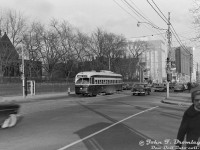 TTC PCC 4404 (A7-class, CC&F 1949) heads westbound on Bloor Street West at St. George Street. At the time, this stretch of Bloor was home to the busy Bloor streetcar route, until it was replaced with the newly constructed crosstown Bloor-Danforth subway line in February 1966. The building on the left (NE corner at 135 St. George) is The York Club, a very old social club founded in 1909 and still present there today. In the distance is the large office tower at Bedford (that at one point housed Texaco offices), and beyond are the high rises and stores around Bloor and Avenue Road (including the Park Plaza Hotel). The University of Toronto's sprawling St. George campus to the south is on the doorstep to all of this.
<br><br>
In all my time collecting slides/negatives and looking at old photos, I've never seen a photo of a streetcar taken here, except this one. Most photos in the area tended to have been shot <a href=http://www.railpictures.ca/?attachment_id=56353><b>to the east near Bedford</b></a> due to the appeal of activity around the old streetcar loop, or to the west at <a href=http://www.railpictures.ca/?attachment_id=25655><b>Spadina</b></a>. Having done a stint at UofT in the past, I passed by this intersection daily going to/from the subway, but never grasped a streetcar once stopped here as I waiting for the light to cross. A heartfelt thank you to people like the late John Bromley, Robert McMann, and those older photographers (some still with us) for documenting such scenes of the past.
<br><br>
<i>John F. Bromley photo, Dan Dell'Unto collection negative.</i>