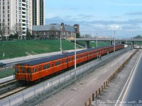 An 8-pack of the TTC's 1950's Gloucester G-series subway cars (the original Red Rocket subway cars built overseas in the UK for the Yonge line) head northbound past maintenance workers on the new Spadina subway line extension, ducking under Ridelle Avenue between Eglinton West and Glencairn subway stations. To achieve the full consist length, the shorter G-series cars were coupled up into trains of eight cars, versus trains of six of the regular 75' aluminum Hawker Subway cars.<br><br>While the new subway extension from St. George to Wilson opened in January 1978, work was still progressing on the nearby Allen Road (aka the failed Spadina Expressway). One idea that did survive all the grassroots protesting and political fighting around the expressway construction was the idea of building a rapid transit line up the center of it, perfectly depicted here, and today reaching as far north as the City of Vaughan.<br><br><i>Original photographer unknown, Dan Dell'Unto collection slide.</i>