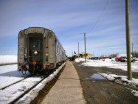 <b> A paddle on the rear </b> <br>
VIA 8224 Chateau Roberval carries the markers (or in today's display, the paddle) on the rear of VIA 692. <br>
Backed into the station at Thompson, MB for its scheduled stop, passengers mill about the station area, baggage gets handled by local VIA personnel, and the head end crew swaps out. <br>
There is still a lot of snow on the ground for May 1st. There are concerns for the amount of water that will be present along the right-of-way when the melt comes.