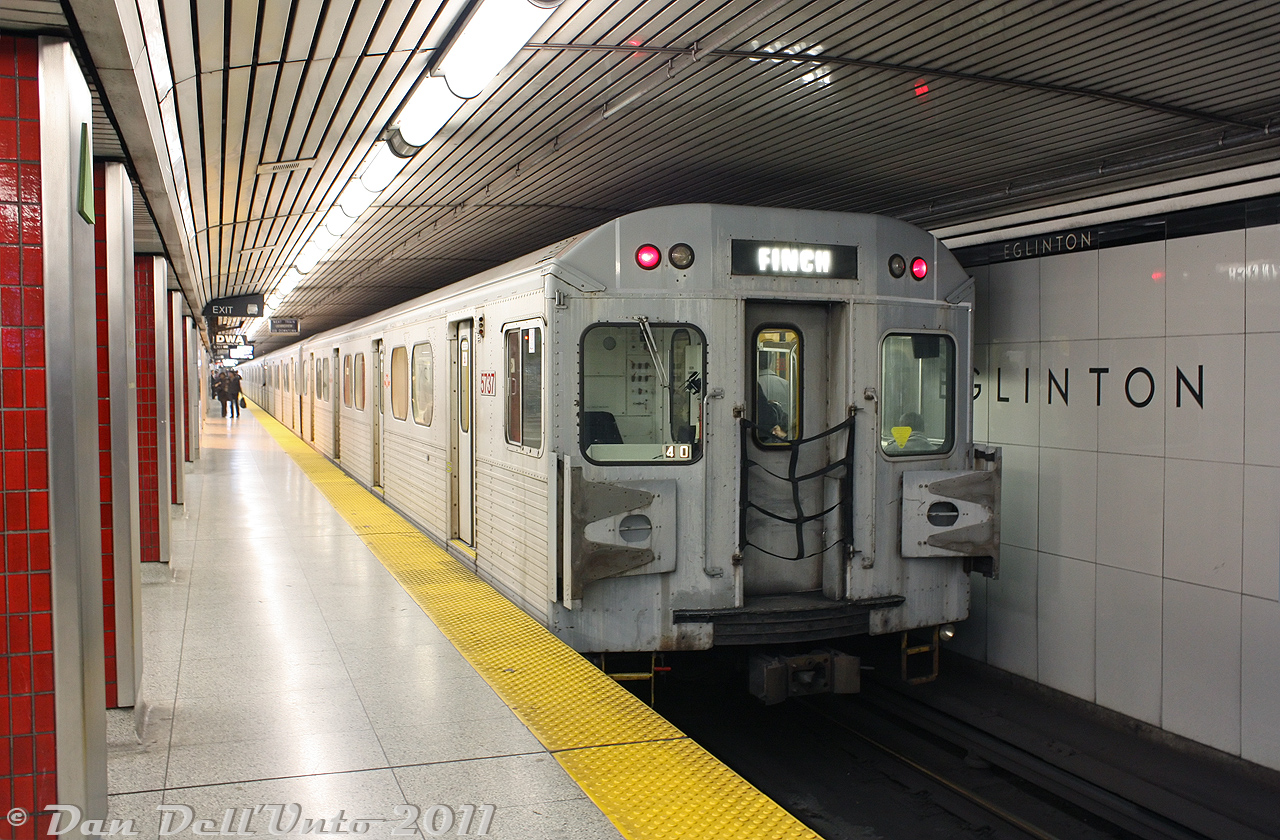 TTC H5 5737 pauses at Eglinton Subway Station, trailing a southbound train on the Yonge portion of the Yonge-University-Spadina line (Line 1 today). Eglinton Subway Station is the only station on the original 1954 Yonge Subway line that retained most of its Vitroline glass tiles, original to the station's construction. This photo was also shot before the TTC started removing the roof slats above the track area, due to the new TR trains' rooftop HVAC systems blowing all the built-up grime out (the stations looked better with the full roof slats though, the unfinished roof look left much to be desired).