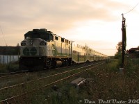 GO Transit F59PH 536 slingshots past on the tail end of train #269, the last evening Union-Bramalea train, on the final push to Bramalea at sunset. The head-end is approaching Halwest (junction with the Halton Sub, and the Mississauga-Brampton boundary line along the hydro corridor), but it should be a straight shot from the Weston Sub onto the Bramalea commuter lead (Platform 3) to unload and deadhead back to Toronto empty. The train is on time out of Malton, and the commuters are happy.<br><br>Torbram Road was home to the most horrible, decrepit, poorly-maintained and rut-plagued multi-track grade crossing in Peel Region, here where the CN Weston Sub crossed. Years of pounding by heavy truck traffic had taken their toll, and the tire ruts were so bad you had to crawl over the crossing if you valued your vehicle's suspension and keeping your spine intact. All of this was turned into a big hole in the ground a few years later when Metrolinx, who became owner of the Weston Sub in 2009, grade-separated Torbram Road (you can't get this shot anymore!). GO 536 was sold to RB Leasing, and eventually converted into a control cab for NC-DOT in North Carolina (RNCX 101).
