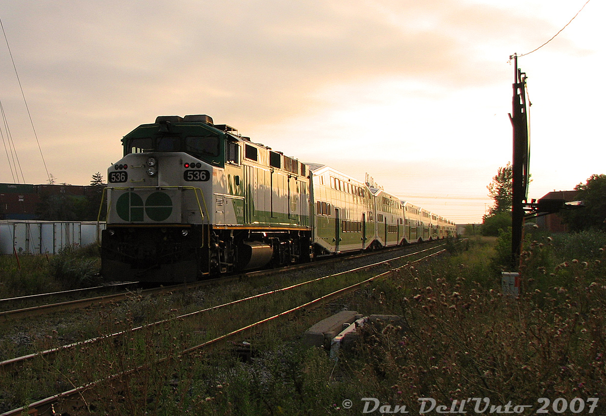 GO Transit F59PH 536 slingshots past on the tail end of train #269, the last evening Union-Bramalea train, on the final push to Bramalea at sunset. The head-end is approaching Halwest (the Mississauga-Brampton boundary line along the hydro corridor), but it should be a straight shot from the Weston Sub onto the Bramalea commuter lead (Platform 3) to unload and deadhead back to Toronto empty.Torbram Road was home to the most horrible, decrepit, poorly-maintained and rut-plagued multi-track grade crossing in Peel Region, here where the CN Weston Sub crossed. Years of pounding by heavy truck traffic had taken their toll, and the tire ruts were so bad you had to crawl over the crossing if you valued your vehicle's suspension and keeping your spine intact. All of this was turned into a big hole in the ground a few years later when Metrolinx, who became owner of the Weston Sub in 2009, grade-separated Torbram Road (you can't get this shot anymore!). GO 536 was sold to RB Leasing, and eventually converted into a control cab for NC-DOT in North Carolina (RNCX 101).