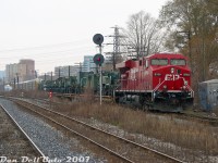 Right place, right time: during our GO train's wait at CN Keele (St. Clair Ave. W underpass) for the light at West Toronto to proceed south, CP train #116 shows up heading down the MacTier Sub with ES44AC 8764 in the lead, and a nice cut of green Canadian Armed Forces military vehicles on the head end (possibly bound for CFB Petawawa). The train is just passing the switch for the connecting track between the CN Weston Sub and CP MacTier Sub (allowing CN trains to enter CP's West Toronto/Lambton Yards to interchange traffic). In the foreground, the double-track CN Weston Sub turns into single track.<br><br>A few minutes later, GO #251 put in an appearance, snaking around our train on its trip north to Bramalea: <a href=https://www.railpictures.ca/?attachment_id=59199><b>https://www.railpictures.ca/?attachment_id=59199</b></a>.<br><br>There was one GO passenger today not complaining about all the delays on his train ride in!