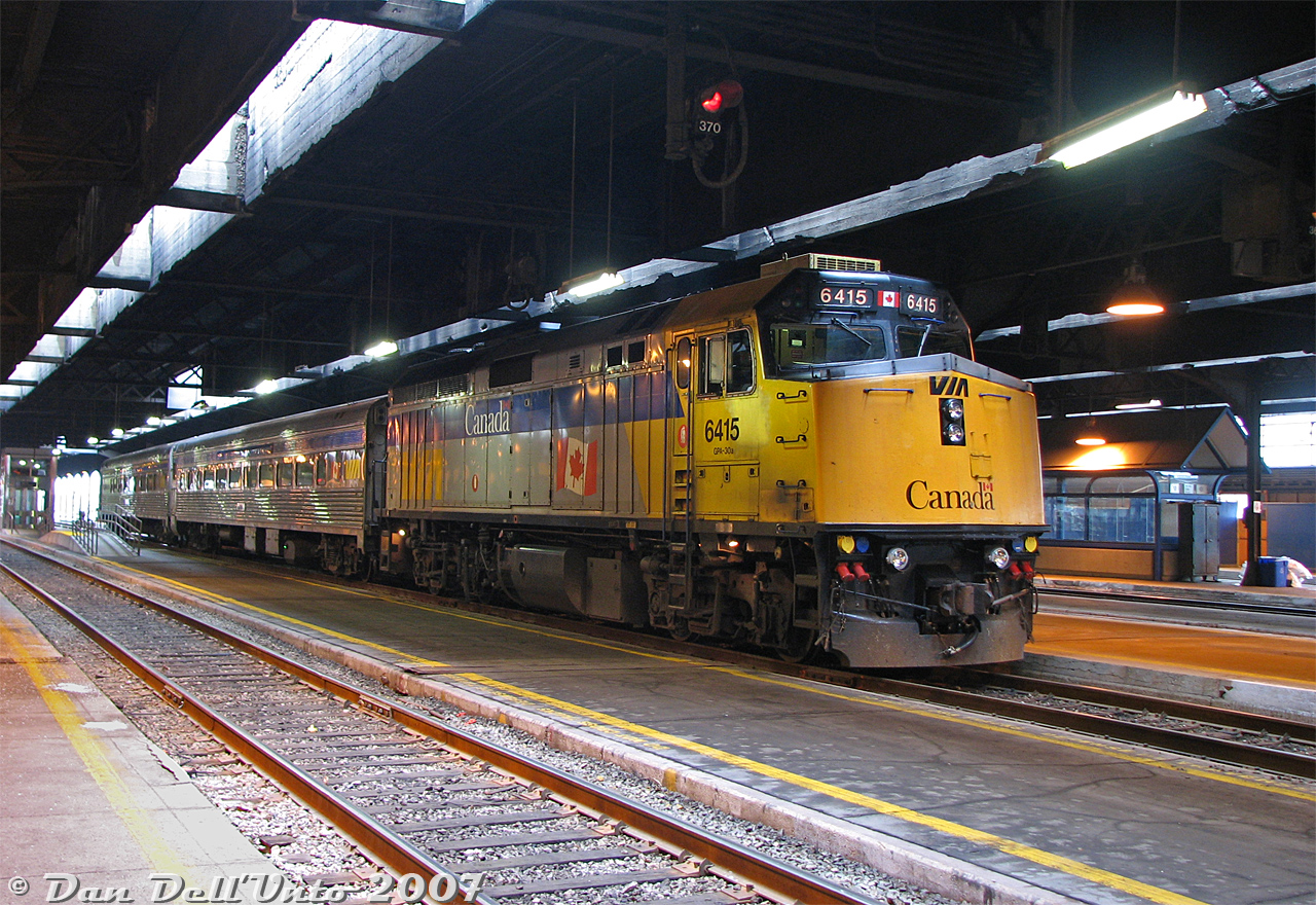 VIA Rail train #85 sits on Track 8 under the Union Station train shed in downtown Toronto, taking on passengers as it awaits its daily 10:55am departure from Toronto to Sarnia. F40PH-2D 6415 does the honours today, with two heavily refurbished 1950's Budd stainless steel coaches trailing. 

This is one for the Guelph/Kitchener fellows that used to get excited for shooting VIA #85, but never shot it in Toronto. Commuting in/out of downtown, the sight of #85 was anything but exciting: always a boring VIA F40 with two stainless steel Budd coaches, all day, every day. Exciting for #85 was when it ran 3 cars, which wasn't saying much, or had one of the wrap units. 6415 also had an ugly yellow mis-match of a patch job on the cab for a while, also unappealing (at least its nose flap was closed today).

Still, a bit more appealing than a grey, black and yellow Siemens trainset, I suppose...
