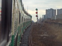 We're riding GO train #260 today (Bramalea-Union), looking at the front of our train as GO Transit F59PH 521 in the lead is about to knock down the light at <a href=https://www.railpictures.ca/?attachment_id=59199><b>CN Keele</b></a> on the approach to West Toronto diamond. The double towers of the Crossways Mall are visible in the distance, as is the Wallace Avenue pedestrian footbridge near our next stop at Bloor GO Station. This consist was run as an L8 at the time (locomotive + 8 bilevels, easy to count from outside the train), and one can see the side indicator light illuminated for the 5A accessible car (the red on the other car is a reflection of the signal). The other thing that sticks out is the sheer amount of rivets on the older bilevels, pre-dating the switch to welded construction in the 90's.<br><br>To appease any concerned Metrolinx staff reading this, this photo was not taken while hanging off the side of a bilevel outside of the train at speed (don't hang off the sides of moving GO trains, kids), nor was it taken poking out an open bilevel window: rather, it was the ol' "trick mirror shot", shot looking into the side mirror of cab car 241 and flipped horizontally to its proper orientation. Today one can't really do this kind of shot anymore since the new cab cars are fully closed off, unless you get an old one with the cab door only shut on the engineer's compartment...(which always meant a nice ride on the conductor's side with such luxuries as a table(!) and full view out the rear).