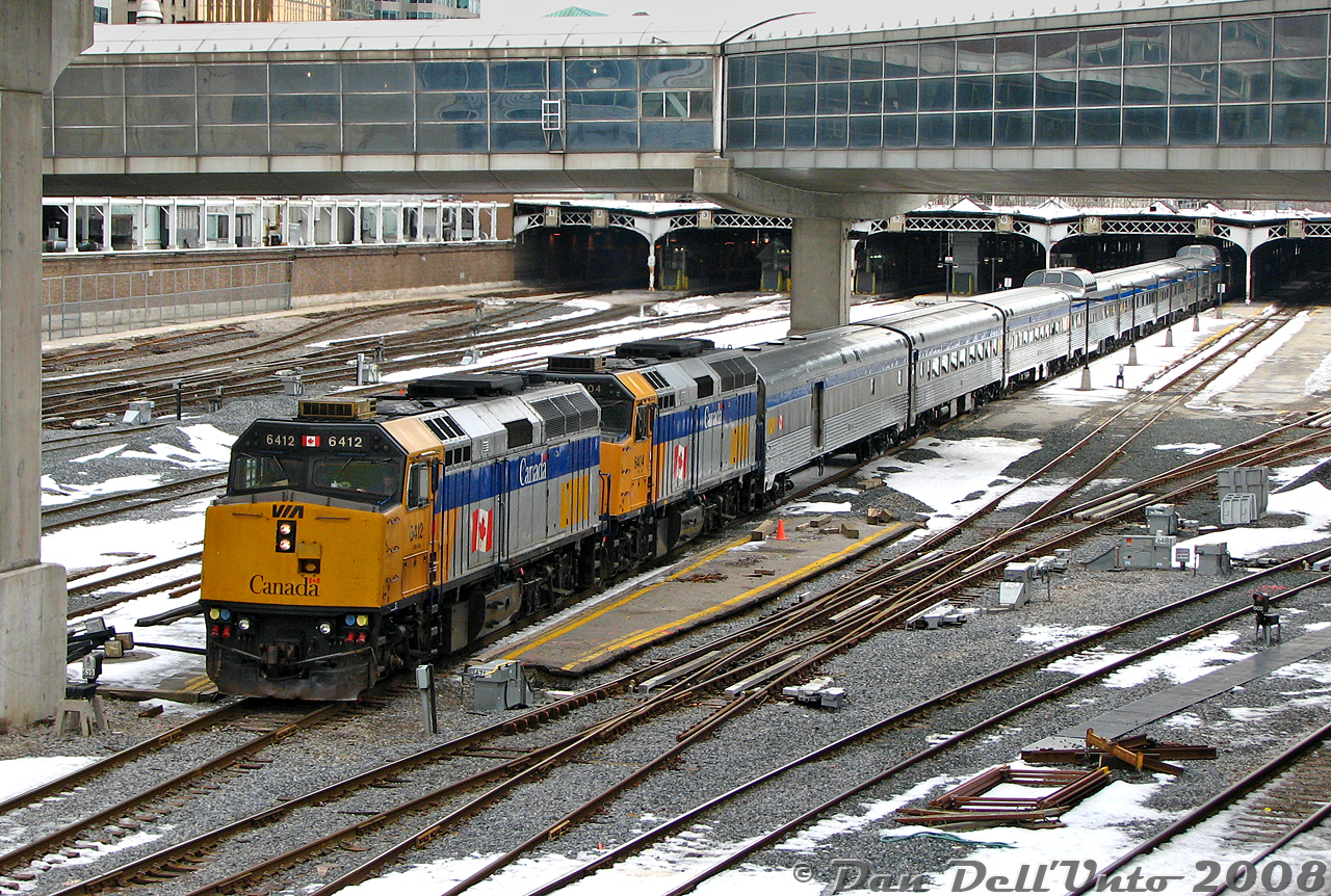 Most people seem to shoot The Canadian at Bathurst Street or up at Snider, catching it departing Union Station isn't as photogenic due to all the pedestrian bridges, the tight corridor, and limited spots to shoot the entire train. However, since we were in the area one afternoon, a late departing #1 offered the opportunity to quickly catch it departing Union Station on its cross-country trip to Vancouver, roughly an hour and a half late (regular departure time 9am).

Today's consist was lead by VIA F40PH-2D units 6412 and 6404, followed by baggage-dorm 8606, coaches 8103 and 8139, Skyline dome 8517, sleepers Stuart Manor, Craig Manor, Osler Manor, Skyline dome 8500, diner Palliser, sleepers Brant Manor, Lorne Manor, Bell Manor, and dome-observation Waterton Park on the tail end.