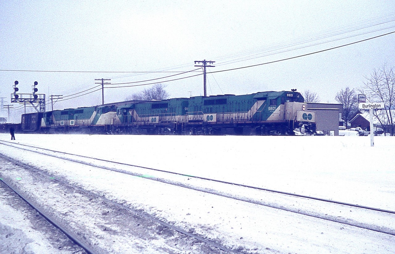 Just over a dozen years ago I posted an image taken at Aldershot showing 4 GO units on weekend lease to CN. Comments were that "I didn't know CN leased GO" to, "are you sure this isn't a CP train over CN"?? as it did look rather unusual to say the least.
After all this time, I found a slide I knew I had that pretty much confirms this was a CN train and they indeed leased GO power for a time.
This image shows GO 9801, 9804, 710 and 709 powering a CN train as it is heading up the Halton Sub to MAC.
And it is late day on a Sunday, so I would assume they had to get this power back to GO in order for the units to be ready for morning.  Just assuming. On the right is the "Burlington" sign before they added "West".
