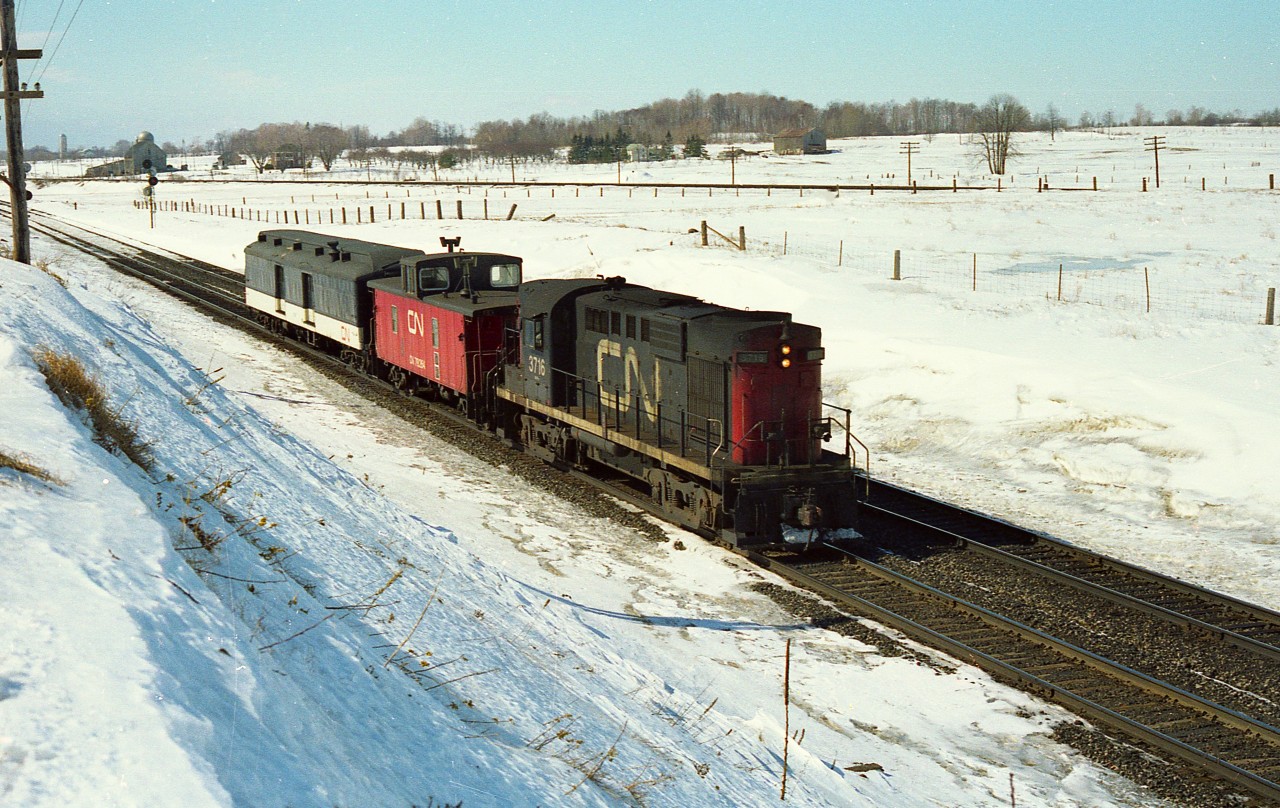 While hanging out at one of the wooden bridges over the CN line at Newtonville, this unexpected move came by.
Back then, no communication like there is today, so no one to ask and no idea where the baggage car was heading.