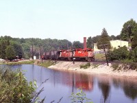 A perfect summer's afternoon in Campbellville down by the pond. Probably those at the picnic benches have little interest in what goes by. Heading west over the Guelph Line are a pair of GP35s, 5015 and 5007; a model that is now but a memory on the CP. These two, as well as numerous others, were sold to Helm Financial in 1998/99.
