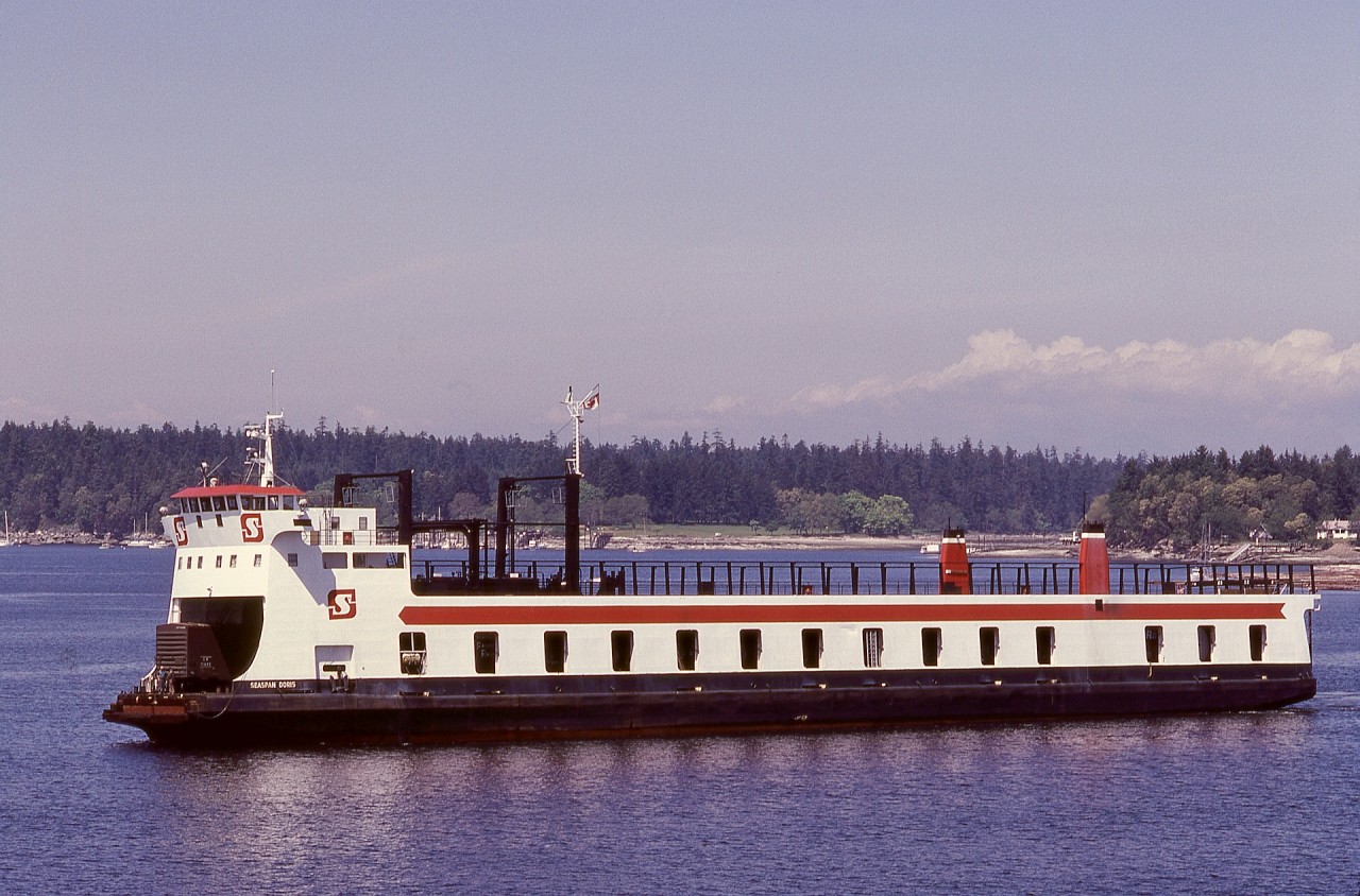 To connect Vancouver Island railways and the continental rail system, a range of marine transportation was utilized.  A regular visitor to Wellcox barge slip in Nanaimo was the unique SEASPAN DORIS (former Doris Yorke), capable of rail and highway vehicles, with an elevator for also carrying trailers on the top deck.  In this view, SEASPAN DORIS is arriving Wellcox from Vancouver, with one boxcar first-up, on Saturday 1980-05-17.
