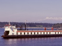 To connect Vancouver Island railways and the continental rail system, a range of marine transportation was utilized.  A regular visitor to Wellcox barge slip in Nanaimo was the unique SEASPAN DORIS (former Doris Yorke), capable of rail and highway vehicles, with an elevator for also carrying trailers on the top deck.  In this view, SEASPAN DORIS is arriving Wellcox from Vancouver, with one boxcar first-up, on Saturday 1980-05-17.