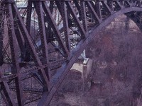  Since I never had the opportunity to be on a train over this bridge, I can only imagine what it would feel like looking out the window. Not like being on a road where you can see the shoulders. Gads!!  What a long way down.
This image is of CP 8227 and 8234, a pair of GP9u locomotives now gone from the system; on their way into Canada. When rail traffic left downtown Niagara Falls in 2000, the bridge was abandoned. Too costly to tear it down.