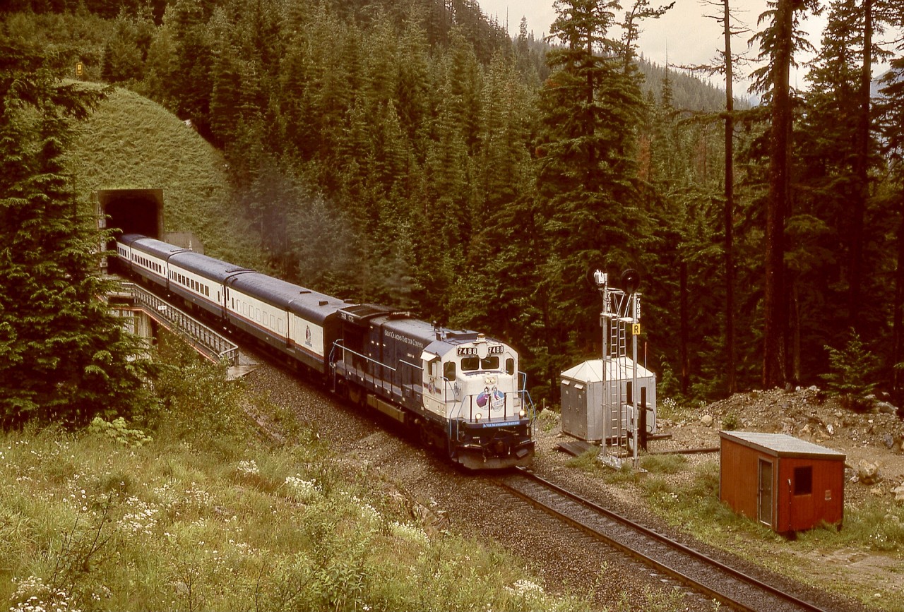 Emerging from the west portal of the Shaughnessy Tunnel on the Macdonald Track and on the bridge over Bear Creek on Sunday 1995-08-06 at 1258 PDT is ex-ATSF now GCRC 7488 and a westward train from Calgary.  This was during closure of the Connaught Tunnel for deepening to handle double-stack trains, with mechanical staff camped nearby to ensure two-way rail traffic remained fluid.  Paid to railfan for two weeks for me!