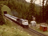 Emerging from the west portal of the Shaughnessy Tunnel on the Macdonald Track and on the bridge over Bear Creek on Sunday 1995-08-06 at 1258 PDT is ex-ATSF now GCRC 7488 and a westward train from Calgary.  This was during closure of the Connaught Tunnel for deepening to handle double-stack trains, with mechanical staff camped nearby to ensure two-way rail traffic remained fluid.  Paid to railfan for two weeks for me!