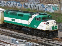 The phrase "faster than a speeding locomotive" comes to mind as GO Transit F59PH 556 clatters through the switches at Bathurst Street, leading inbound Bradford (now Barrie) line train #802 on its last mile to Toronto Union Station in the morning. The "graffiti wall" behind was once part of an old <a href=http://www.railpictures.ca/?attachment_id=37558><b>Consumer's Gas plant</b></a> that was formerly here (complete with gasometer tank back in the day).<br><br>GO 556 was another unit sold off to AMT/exo in 2011 (becoming 1349), and recently purchased back by GO as GOTX 581.