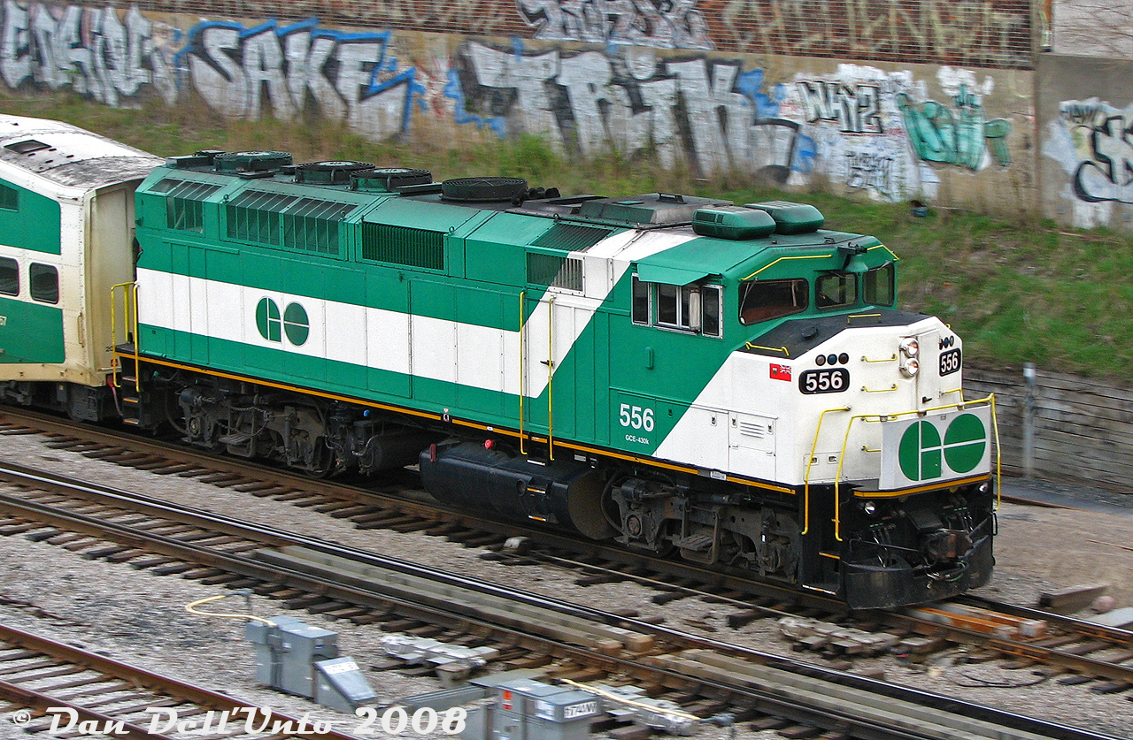The phrase "faster than a speeding locomotive" comes to mind as GO Transit F59PH 556 clatters through the switches at Bathurst Street, leading inbound Bradford (now Barrie) line train #802 on its last mile to Toronto Union Station in the morning. The "graffiti wall" behind was once part of an old Consumer's Gas plant that was once here (complete with gasometer tank).

GO 556 was another unit sold off to AMT/exo in 2011 (becoming 1349), and recently purchased back by GO as GOTX 581.