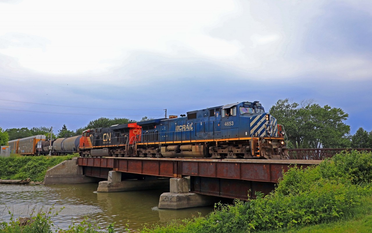 A friendly wave as BCOL 4653 and CN 2250 cross the Belle River with train 438 at mile 90.2 on the Chatham Sub.