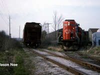 The CN 15:30 Kitchener Job is viewed setting-off one loaded lumber car at Fairway Lumber in St. Jacobs on the Waterloo Spur with 7030 and 4141. The job was on their return trip south to Kitchener when they stopped to set-off the car. At the time, the job only operated with two units when it was necessary and on this day, both Nutrite and Sulco Chemicals in Elmira had received several cars. The springtime was always a busy period for Nutrite receiving hoppers. 