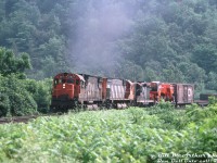 CN C630M 2017, M636 2339 and GP9 4509 grind upgrade with train #401, about to roll though Dundas on the Dundas Sub. A pair of new farm combine loads ride the first flatcar behind the Geep.<br><br><i>Bill McArthur photo, Dan Dell'Unto collection slide.</i>