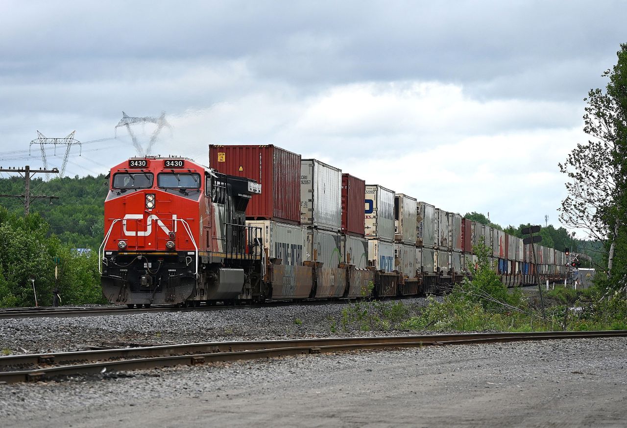 After waiting for the better part of half an hour for VIA Number 2 to make its station stop at Sudbury Junction, this northbound intermodal finally gets moving again.  VIA Number 2 had backed up to the north switch where it entered the siding to continue its southward journey to Toronto.  
The freight had the 3430 leading and mid train DPU 2912.