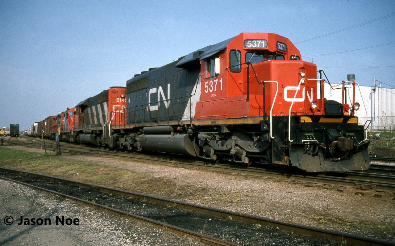 CN 431 with SD40-2 5371, SD40 5142 with GP9RM’s 4137 and 4138 are pictured in the yard at Kitchener, Ontario. The crew had just completed their set-off and were in the process of uncoupling 4138 as well. GP9RM 4137 would possibly be set-off at Stratford or continue on to London Jct.