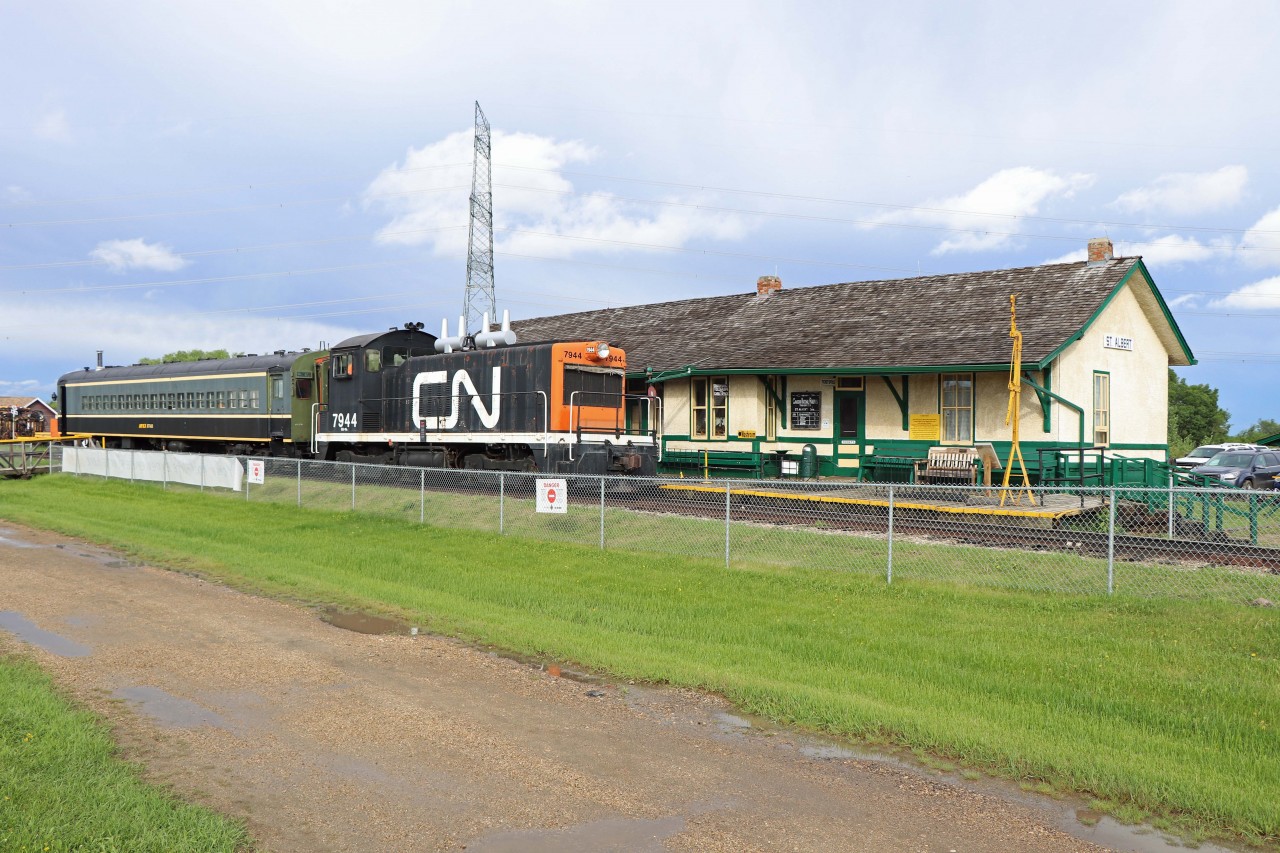 CN NW2 impatiently waits for passengers from the NMRA 6th Division Meet to board at the Alberta Railway Museum gift shop for a train ride (several "back and forth" passes on museum grounds). NW2 7944 was built by EMD in Lagrange in 1946 and donated to the Museum by CN in 1977. Former Montreal commuter car 6740, built in 1952 (an MU trailer in service until 1995), is on loan from Alberta Prairie Railway Excursions in Stettler according to the Canadian Trackside Guide. The station was built by the Canadian Northern Railway in 1909 and moved here in 1973. (The station building now in St. Albert is a replica.)