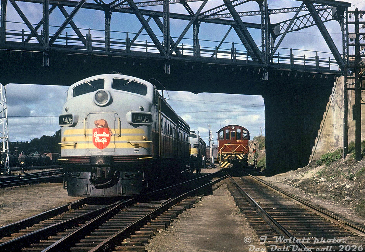 Power for both Montreal and Toronto sections of Canadian Pacific's eastbound Canadian sits waiting under the bridge at Paris Street, as CP S3 7091 shuffles passenger cars east of the station in Sudbury. CP FP9 1406 and an F7B sit ahead, while CP FP7 1423, an F7B and FPA2 sit on the other side of the bridge by the fuel racks.

During CP operation, eastbound train #2 "The Canadian" from Vancouver split at Sudbury, with one train heading east to Montreal as train #2, and the other south to Toronto as train #12. The reverse happened with westbound trains #11 from Toronto and #1 from Montreal combining at Sudbury into #1 for Vancouver. Extra passenger cars would be kept at Sudbury, added or removed from consists as they were broken up or combined. Switching power was typically one of the locally-assigned 7000-series MLW S2 units.

J. Wollatt photo, Dan Dell'Unto collection print.