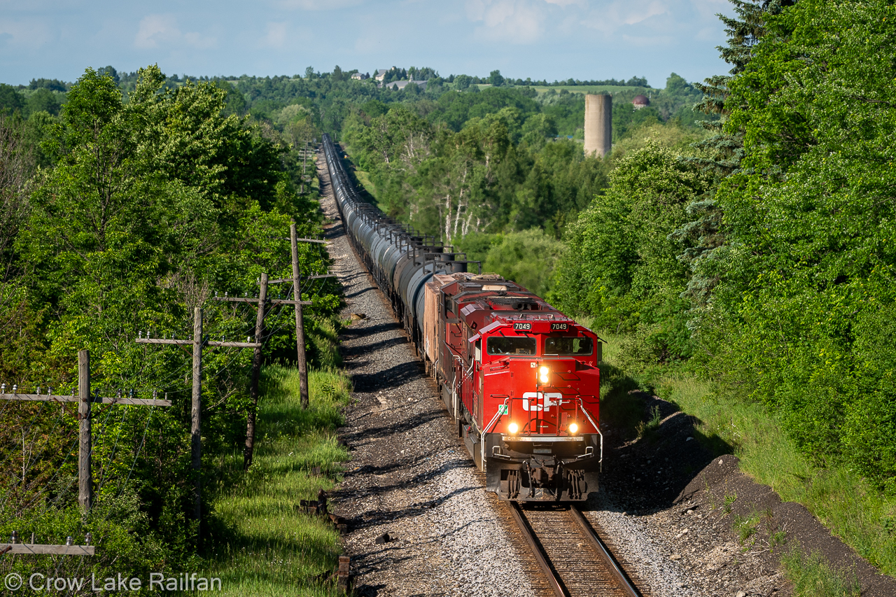 After receiving their written clearance onto the Occupancy Control System (OCS) part of the Galt Subdivision, CPKC train no. 529 eases to a stop at the East Siding Switch Puslinch. Their clearance from J.D. read "clear main track". As RTC has no control over the signals and switches, the conductor will get out and use a pushbutton to activate the switch. Once its in position they'll get a restricting signal into the unsignalled siding. After the last car clears the switch will automatically return to normal and return to clear signals for the train they're meeting.
This system has been around for decades and is slowly being upgraded to CTC in nearby areas. Soon written instructions will be a thing of the past. For now it's great for listening in, getting info for trains and meets. Soon this will be a bygone era in the new age of railroading.