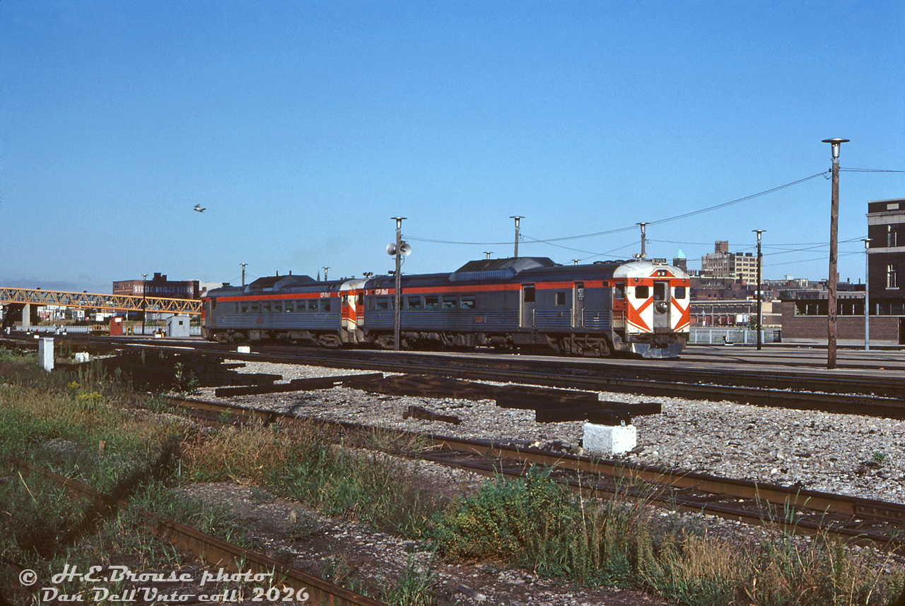 CP Rail RDC-3 9021 trails an RDC-2 (likely 9112) departing Toronto Union Station on train #321 (the CP-TH&B-CR Budd run) to Buffalo. This view is looking northwest from near the foot of the CN Tower (note the yellow CN Tower pedestrian bridge), by the old CN Express building on the right (today part of the Skywalk). The downtown Toronto skyline looks quite bare compared to today. Also note the grey fence along the edge of the rail corridor, where "the fence track" got its name. The shadow of TTR's John Street interlocking tower can be seen on the far left.

Harold E. Brouse photo, Dan Dell'Unto collection slide.

At Fort Erie in 1974: http://www.railpictures.ca/?attachment_id=53884