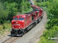 CPKC train 236 is seen entering Hamilton, Ontario as it drops down the grade approaching Newman Road on the Hamilton Subdivision. Powering the southbound are CPKC AC4400CWM 8128 and CP SD70ACu 7052.