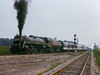 With a small group of excursionists aboard for a short side trip, 6060 swings through the curve at Port Robinson after wyeing the train at Yager.  In the foreground, the Thorold Sub leads north to Merritton.<br><br><i>Allen W. Clum Photo, Jacob Patterson Collection Slide.</i>