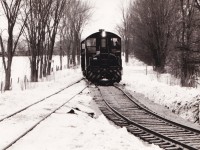 A pair of SW1200RS units enter the newly completed diversion track between the CNR Coldwater spur and the remnant of the CPR Port McNicoll subdivision.

This connecting track permitted CP to reach the CNR Midland sub at Coldwater when the large Hoggs Bay trestle was abandoned in 1971. A similar connecting track was built between McMillan on the Midland sub and the yard at Port. Prior to this CP had an interlocked  diamond crossing of the CN spur. CP used trackage rights on CN to reach McMillan until 1991 when the Port McNicol sub was abandoned. The diamond remained in place for several years until the unused rails were lifted between this point and the trestle.

The connecting track originally dipped south of the existing track before connecting to the existing track near the bridge over the Coldwater river. The connecting track was later reconfigured to a more conventional turn in the 1980's due to difficulties with long trains. Six axle units were prohibited on this later track arrangement. Our family rode a UCRS excursion to Midland that went through this trackage in 1975. It was an interesting sight watching the 80 foot long coaches negotiate the shoofly.

The County of Simcoe mapping website (https://opengis.simcoe.ca/public/) has aerial views of this area. The 1978 and 1983 views show the two different layouts.

Unknown photographer from my collection.