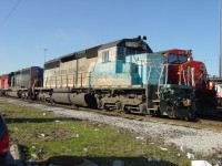 A stranger in town. On 4/24/03, NS SD40-2
#3329 painted in Maersk Sealand livery, awaits assignment on track 29 at CN's Mac Yrd diesel shop.

History: Originally built as Conrail #6358 in 1977, it was later acquired by Norfolk Southern. 
The Paint Job: Painted in a striking light blue and white Maersk Sealand scheme in 2002. 
Purpose: It was painted for a promotional campaign and grand opening of a new Maersk facility on Terminal Island, California, as well as to celebrate railway/shipping partnerships following the enlargement of tunnels for doublestack containers. 
Current Status: It has since been retired from its Maersk livery and repainted into standard Norfolk Southern "Horse Head" black. 
I think a trip through the locomotive wash track is in order.