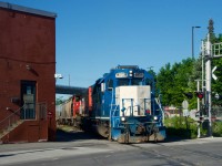 CN 4909 leads CN 500 as it crosses Bridge Street, on its way to switch a grain client in the Port of Montreal.