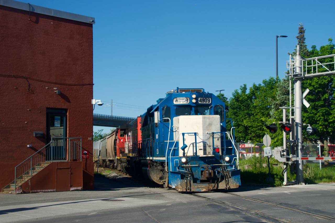 CN 4909 leads CN 500 as it crosses Bridge Street, on its way to switch a grain client in the Port of Montreal.