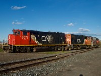 CN YRP003 has three widecab geeps in three paint schemes (CN 9677, CN 4765 & CN 4774) as it leaves where Longue Pointe Yard used to be after dropping off two boxcars at Getpaq.