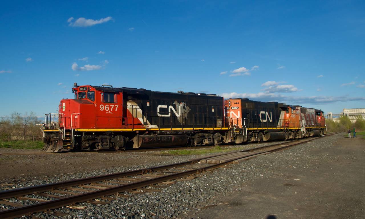 CN YRP003 has three widecab geeps in three paint schemes (CN 9677, CN 4765 & CN 4774) as it leaves where Longue Pointe Yard used to be after dropping off two boxcars at Getpaq.
